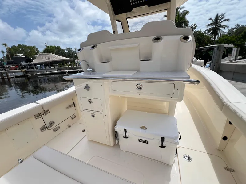 Slide: The Image of 2026 Scout 260 LXF boat interior with storage and Yeti cooler on deck. - 11