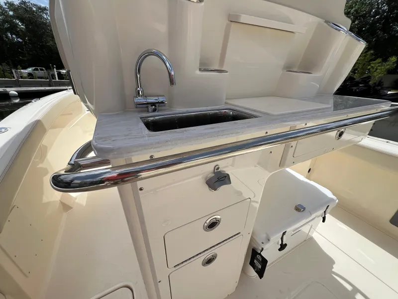 Slide: The Image of 2026 Scout 260 LXF boat interior with sink and storage compartments. - 12