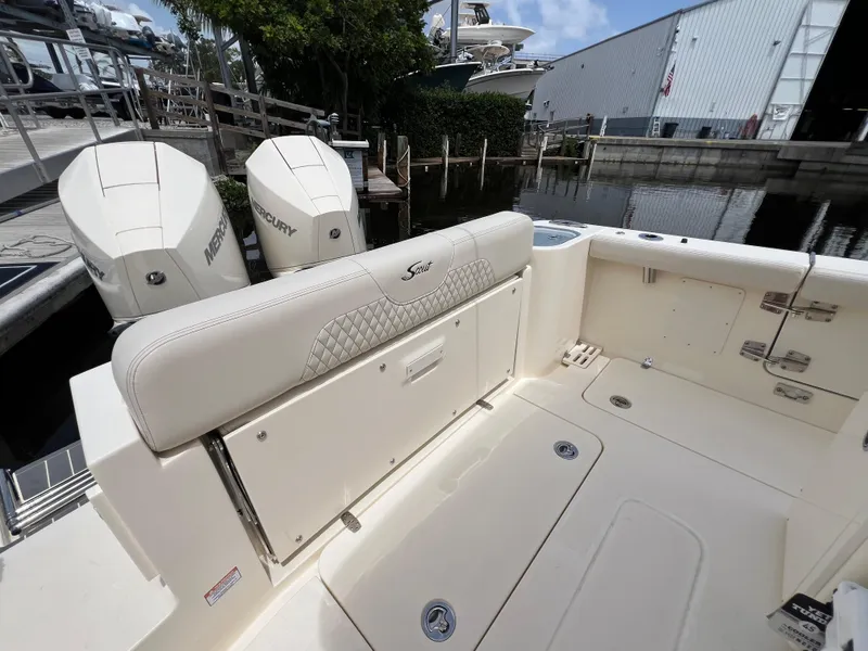 Slide: The Image of 2026 Scout 260 LXF boat interior with Mercury engines at a marina. - 15