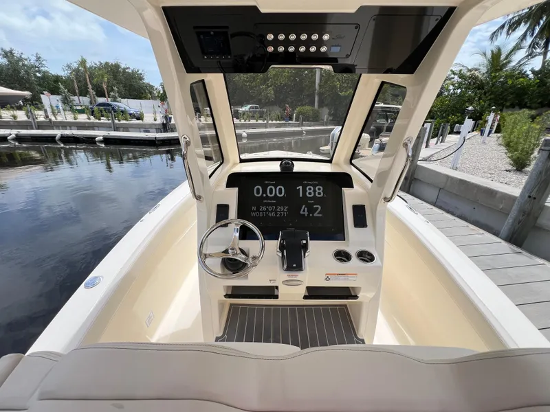 Slide: The Image of 2026 Scout 260 LXF boat dashboard with steering wheel and digital display. - 19
