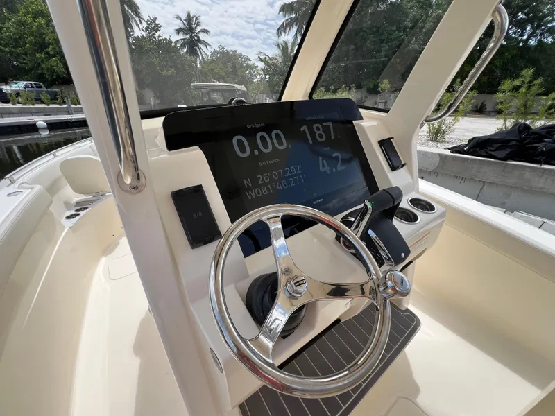 Slide: The Image of 2026 Scout 260 LXF boat dashboard with GPS display and steering wheel. - 22