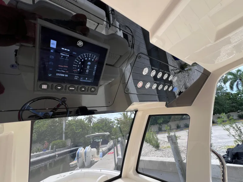 Slide: The Image of Interior dashboard of 2026 Scout 260 LXF boat with control panel and display. - 23