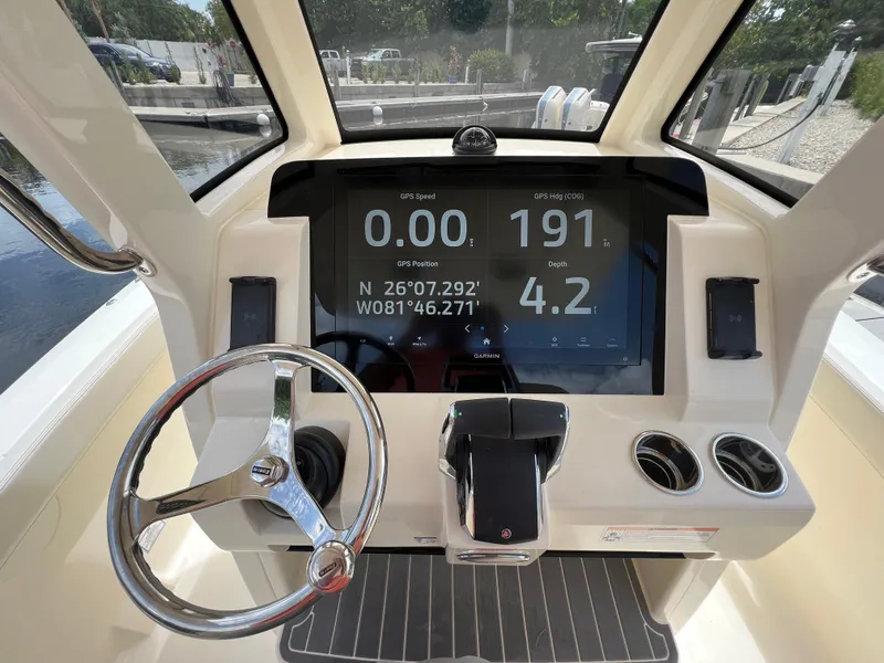 Slide: The Image of 2026 Scout 260 LXF boat dashboard with GPS display and steering wheel. - 24