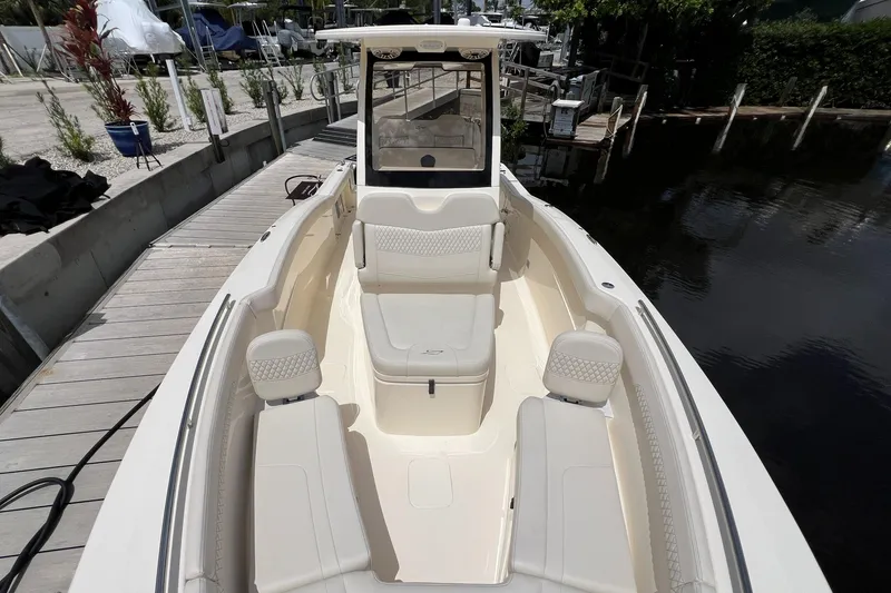 Slide: The Image of 2026 Scout 260 LXF boat with luxurious seating at a dock. - 26