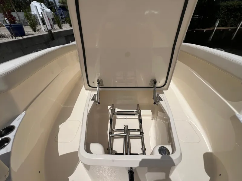 Slide: The Image of 2026 Scout 260 LXF boat with open storage compartment and ladder. - 28