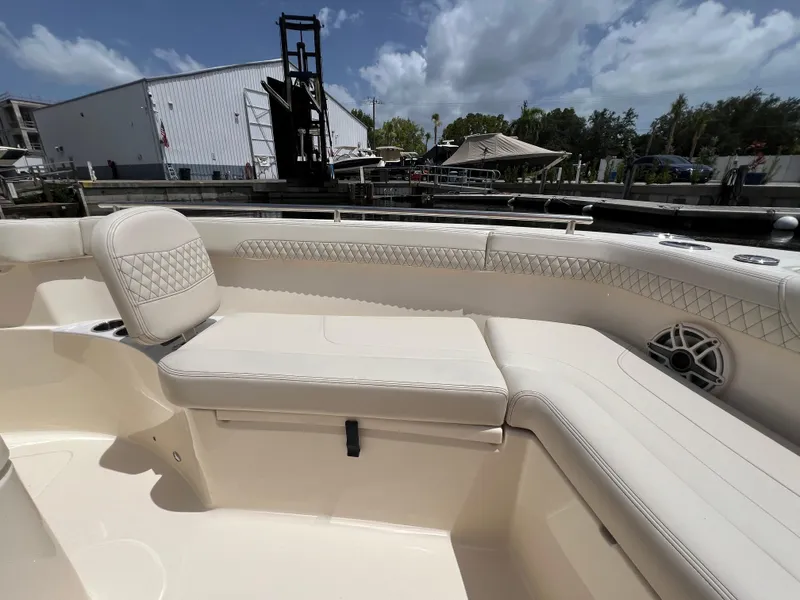 Slide: The Image of 2026 Scout 260 LXF boat interior with luxurious seating and speaker system. - 32