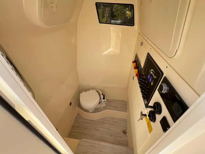 Slide: The Image of 2026 Scout 260 LXF boat interior with control panel and marine toilet. - 34