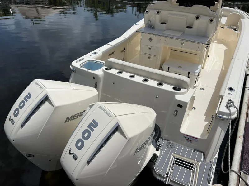 Slide: The Image of 2026 Scout 260 LXF boat with dual Mercury 200 engines, docked on calm water. - 9