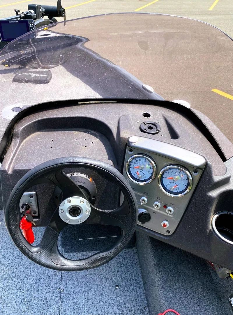 Slide: The Image of 2022 Tracker Pro Guide V-16 SC boat dashboard with steering wheel and gauges. - 10
