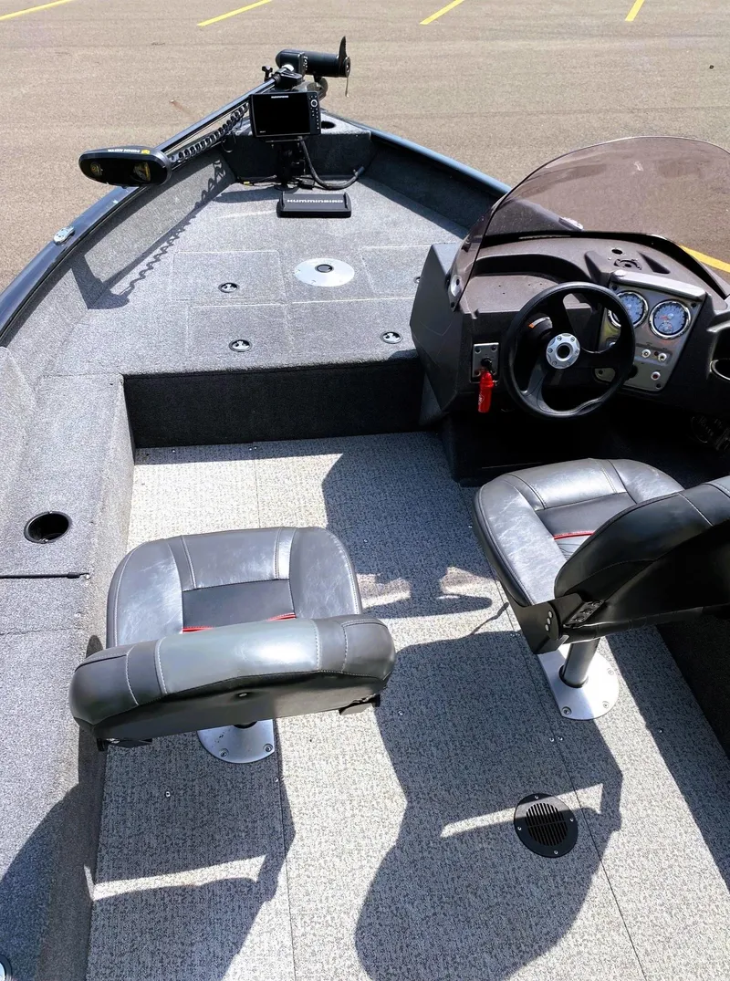 Slide: The Image of 2022 Tracker Pro Guide V-16 SC boat interior with seating and steering console. - 12