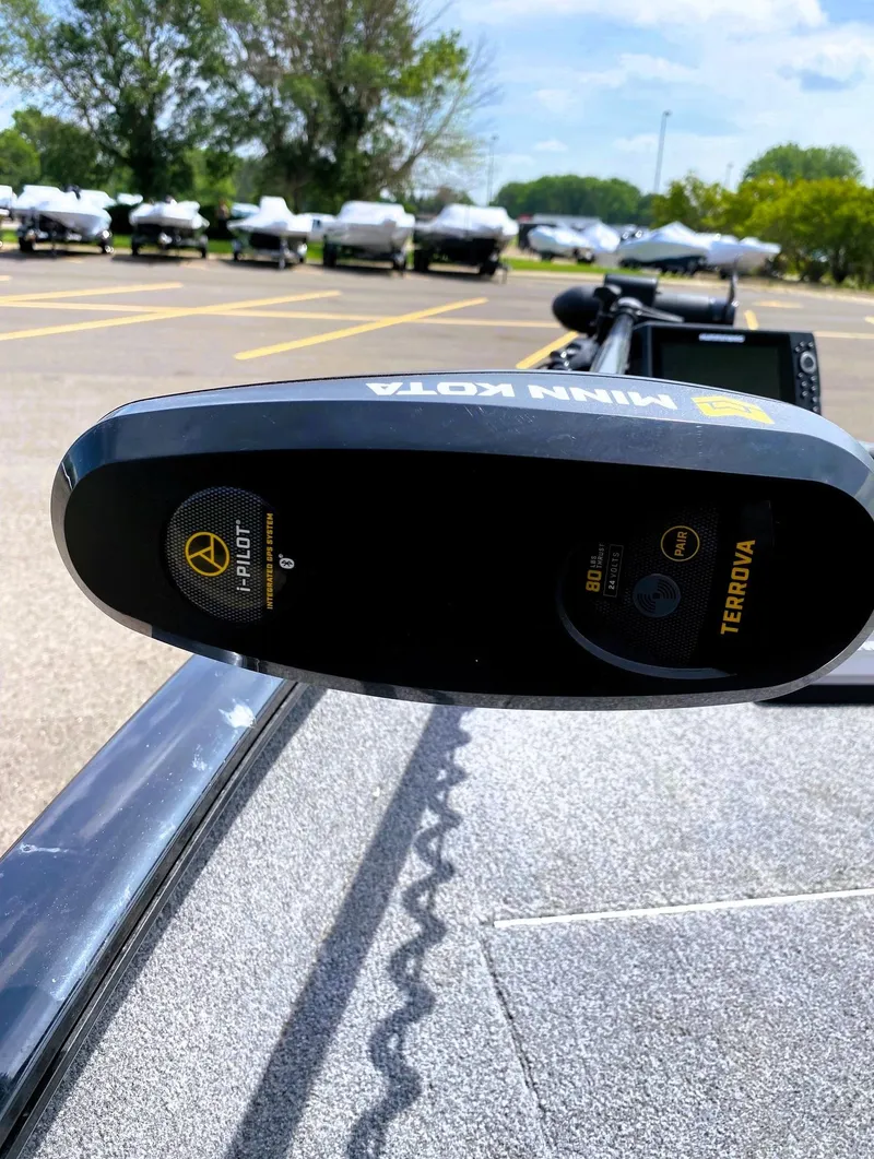 Slide: The Image of 2022 Tracker Pro Guide V-16 SC with Minn Kota Terrova motor in a parking lot. - 7