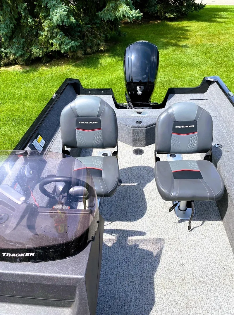 Slide: The Image of 2022 Tracker Pro Guide V-16 SC boat interior with two seats and steering console. - 9