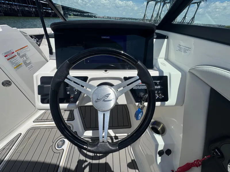 Slide: The Image of 2023 Sea Ray SPX 190 boat dashboard with steering wheel and controls. - 12