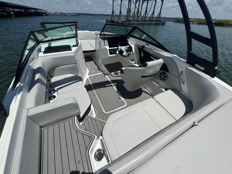 Slide: The Image of 2023 Sea Ray SPX 190 boat interior with sleek seating and modern design on the water. - 14