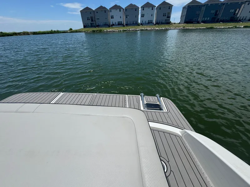 Slide: The Image of 2023 Sea Ray SPX 190 boat on water, with modern houses in the background. - 17