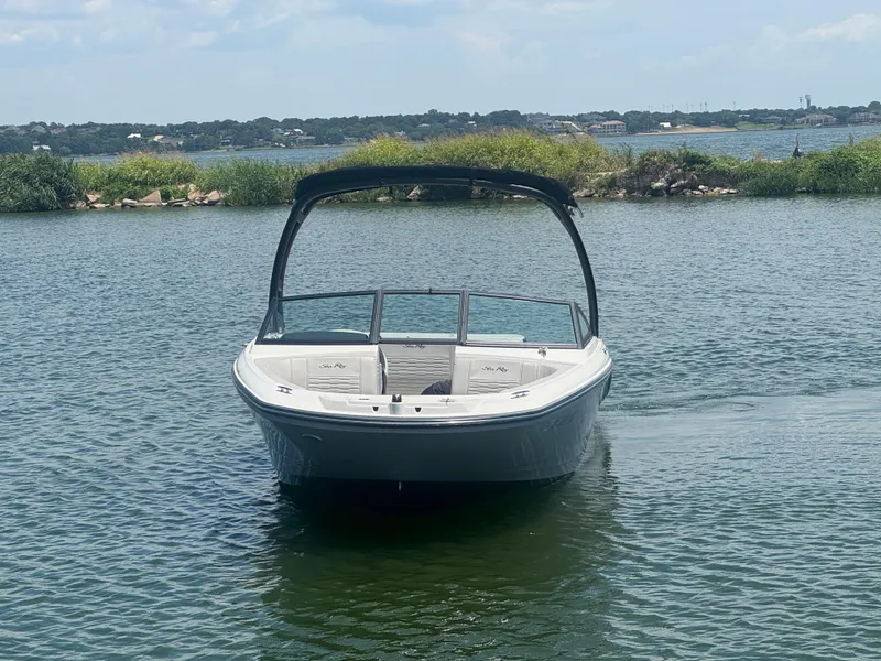Slide: The Image of 2023 Sea Ray SPX 190 boat on calm water with scenic background. - 3