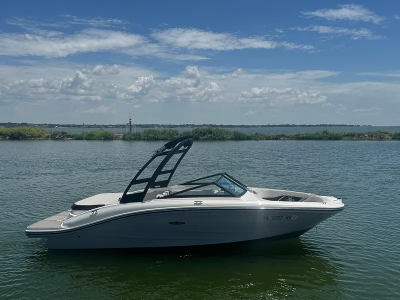Slide: The Image of 2023 Sea Ray SPX 190 boat on calm water under a partly cloudy sky. - 4