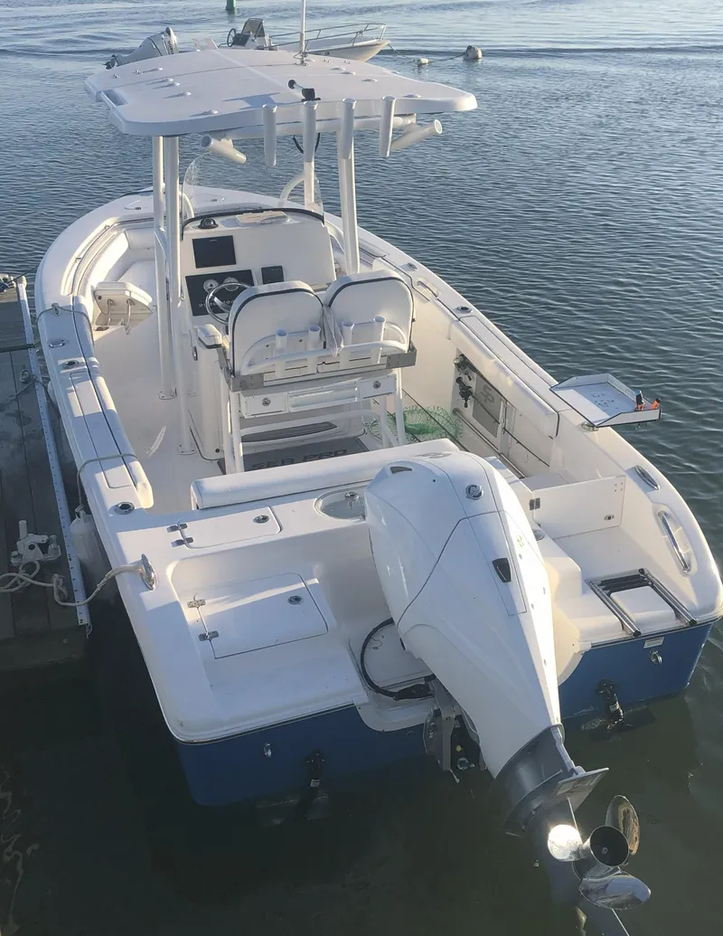 Slide: The Image of 2021 Sea Pro 219 Center Console boat docked on calm water. - 1