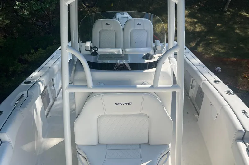 Slide: The Image of 2021 Sea Pro 219 Center Console boat interior with white seating and console. - 2