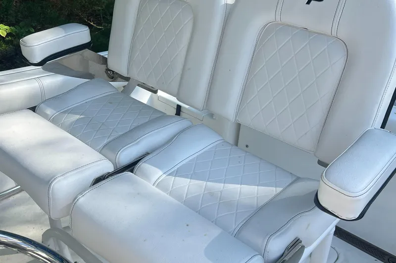 Slide: The Image of 2021 Sea Pro 219 Center Console boat seats with white diamond stitching. - 3