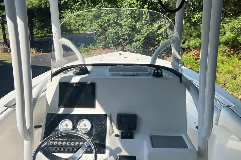 Slide: The Image of 2021 Sea Pro 219 Center Console boat dashboard with steering wheel and gauges. - 4