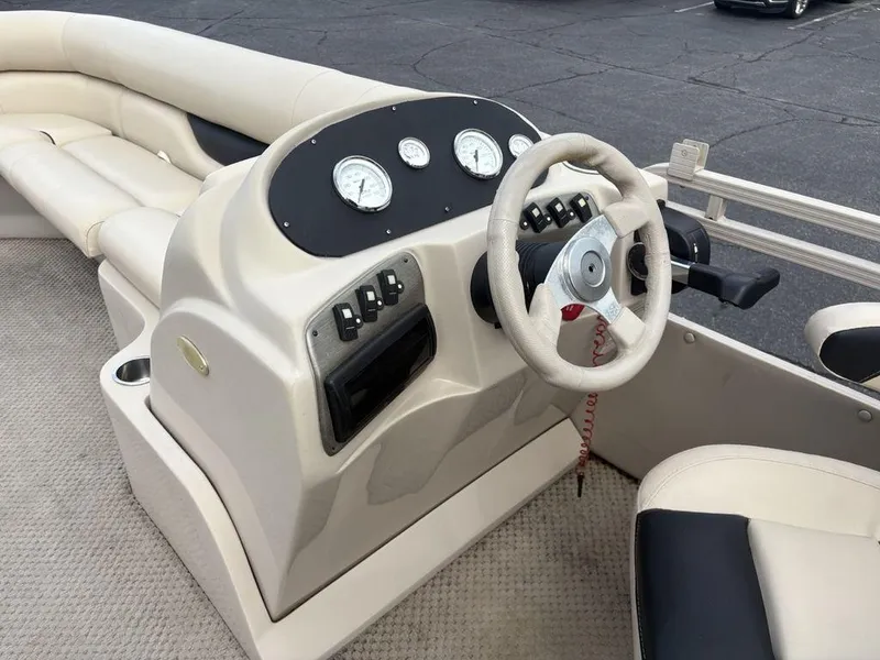 Slide: The Image of 2006 Sylvan 8522 Signature boat interior with steering wheel and dashboard controls. - 10