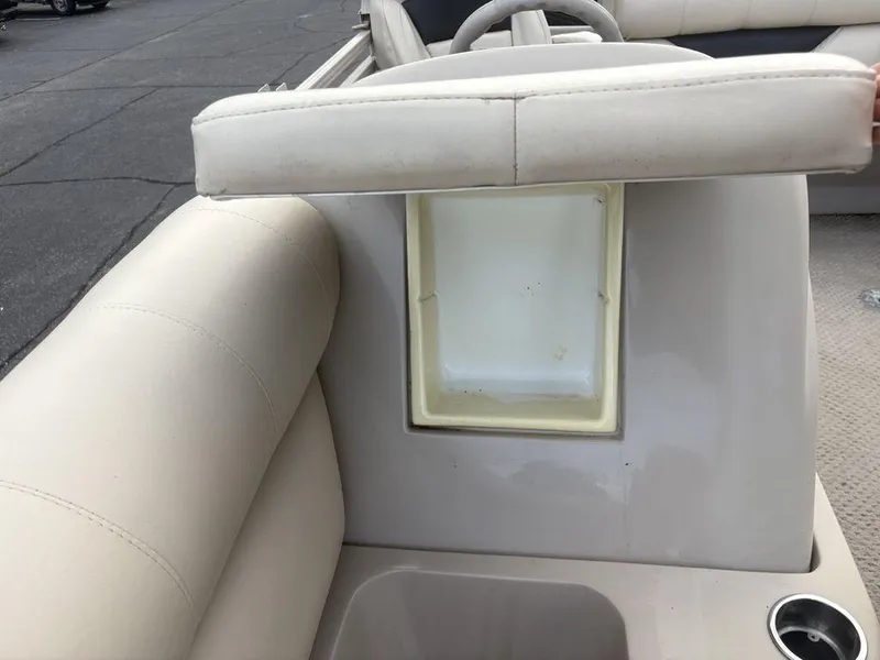 Slide: The Image of 2006 Sylvan 8522 Signature boat interior with beige seating and storage compartment. - 12