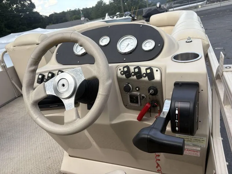 Slide: The Image of Steering console of a 2006 Sylvan 8522 Signature boat with gauges and controls. - 14