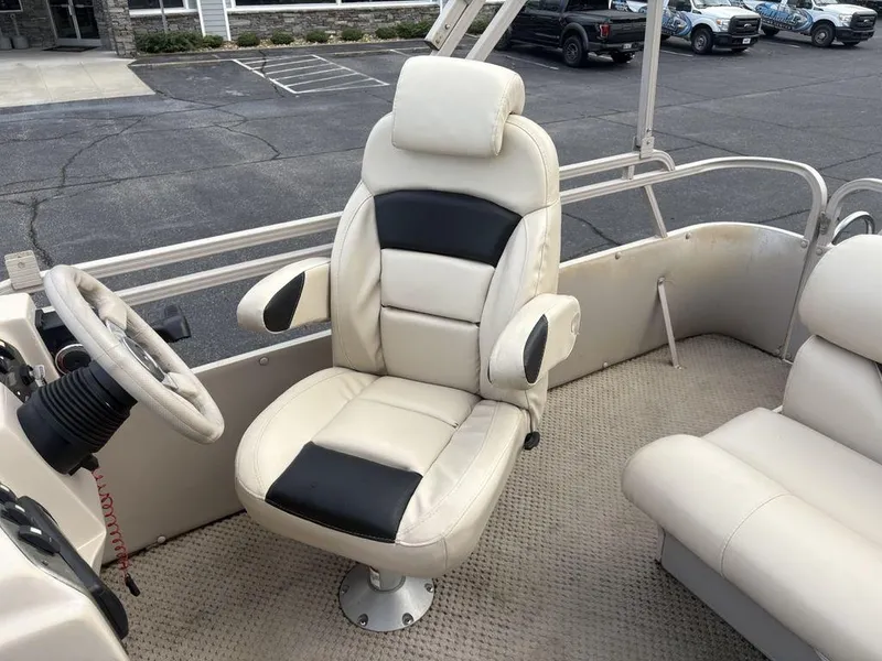 Slide: The Image of Captain's chair on 2006 Sylvan 8522 Signature boat, featuring beige and black upholstery. - 16