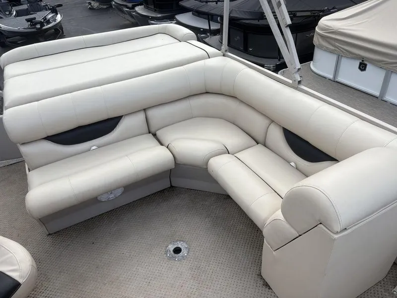 Slide: The Image of Luxurious seating on a 2006 Sylvan 8522 Signature boat, featuring cream upholstery. - 3