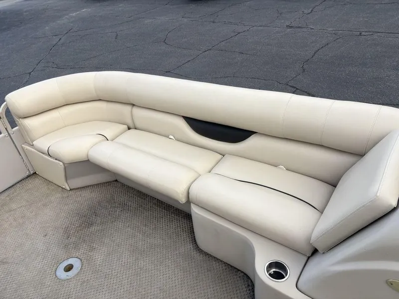 Slide: The Image of 2006 Sylvan 8522 Signature boat interior with beige seating and carpeted floor. - 5