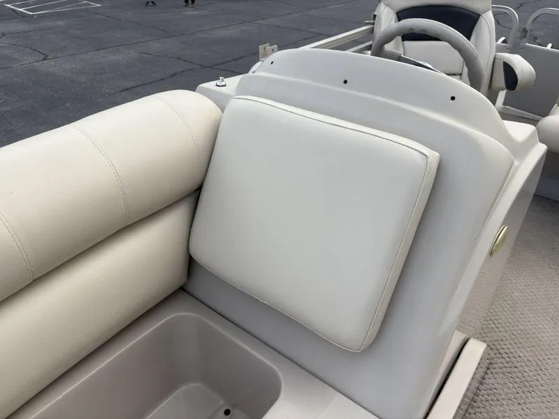 Slide: The Image of 2006 Sylvan 8522 Signature boat interior with beige seating and steering wheel. - 6