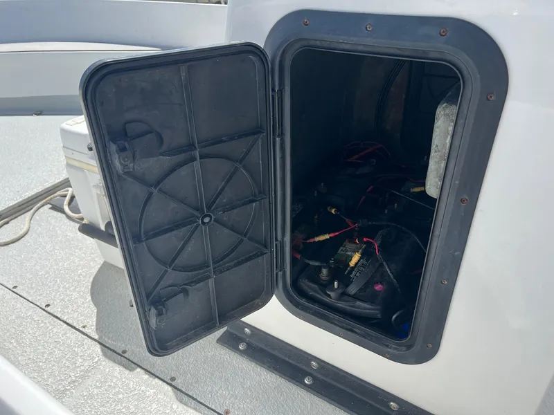 Slide: The Image of Open hatch on 1989 Boston Whaler 23 Guardian, revealing internal wiring and components. - 10