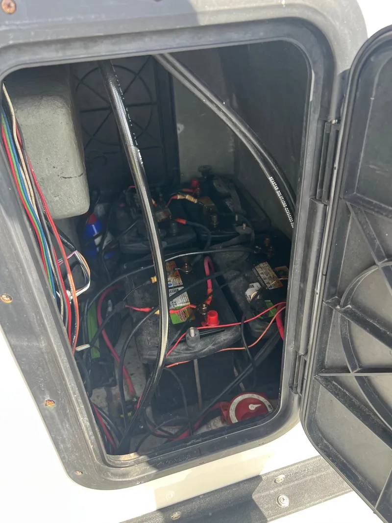 Slide: The Image of Battery compartment of a 1989 Boston Whaler 23 Guardian boat with visible wiring. - 11