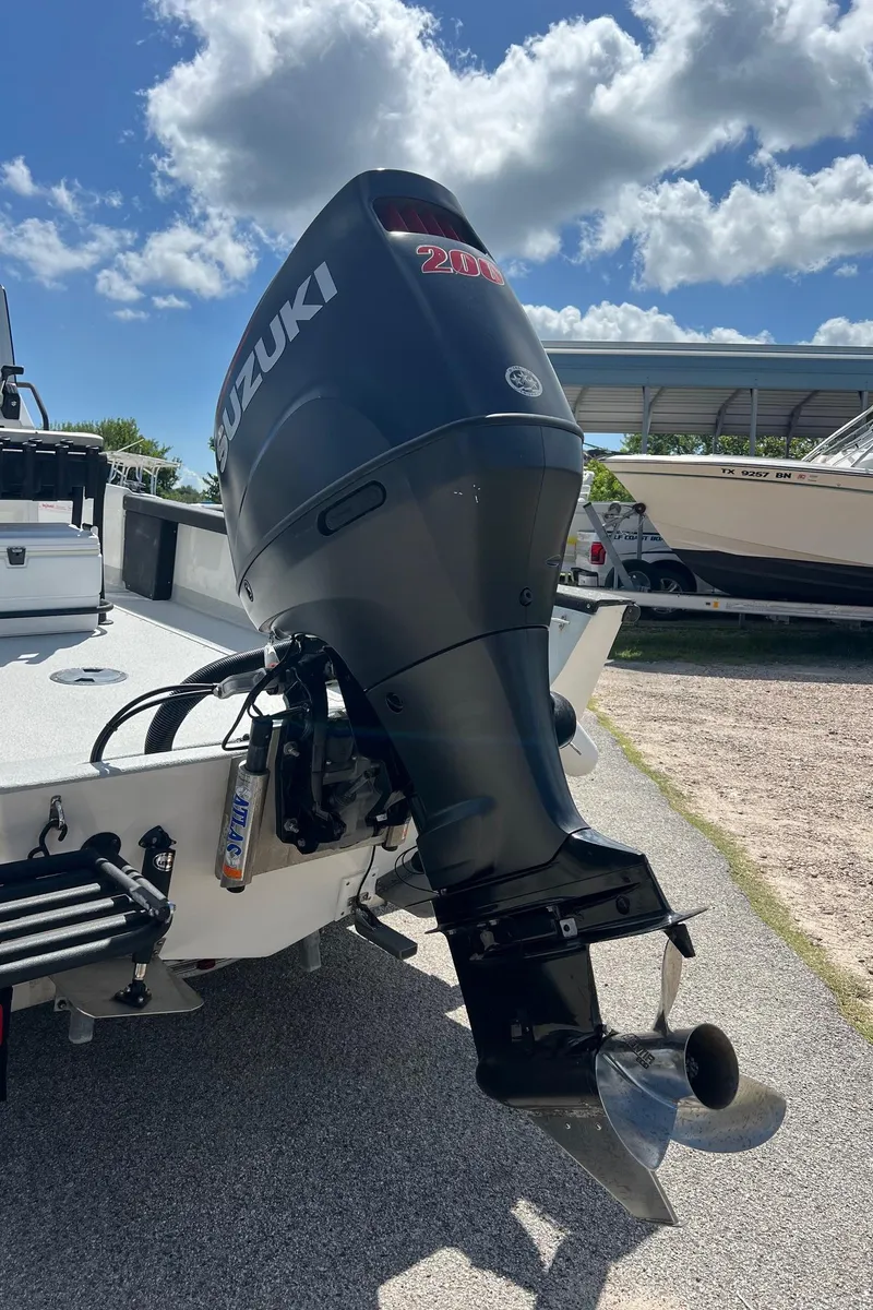Slide: The Image of 1989 Boston Whaler 23 Guardian with Suzuki outboard motor under a sunny sky. - 13