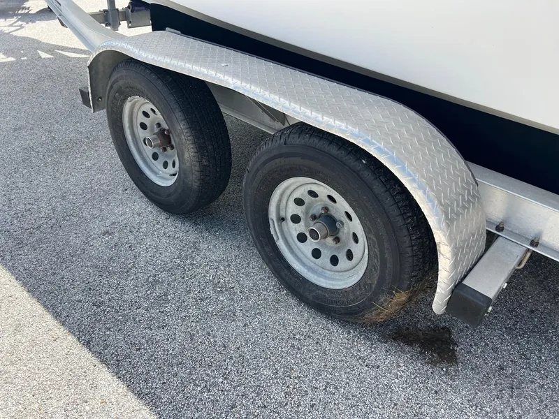 Slide: The Image of Trailer wheels of a 1989 Boston Whaler 23 Guardian on asphalt. - 5