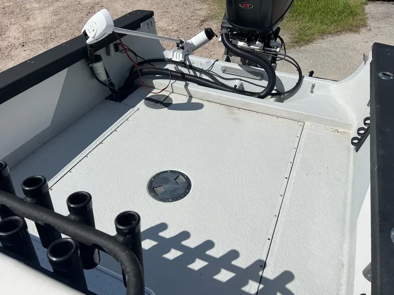 Slide: The Image of 1989 Boston Whaler 23 Guardian boat deck with motor and rod holders. - 6