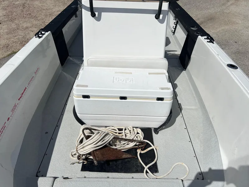 Slide: The Image of 1989 Boston Whaler 23 Guardian interior with cooler, rope, and anchor on deck. - 8