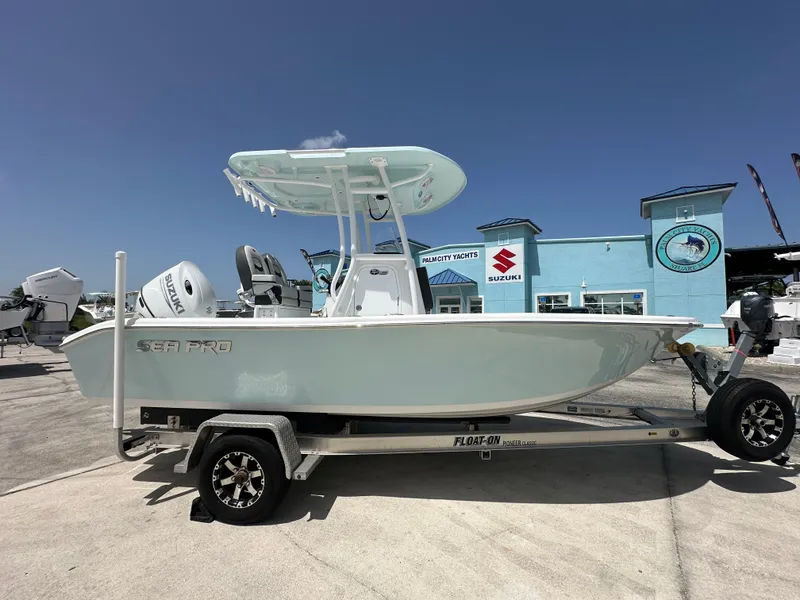 The Image of 2026 Sea Pro 202 Center Console boat on trailer at dealership. - 1