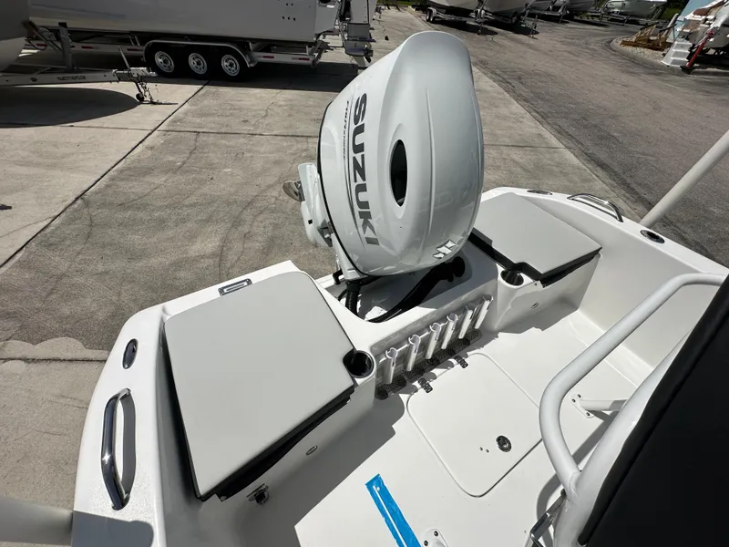 Slide: The Image of 2026 Sea Pro 202 Center Console boat with Suzuki outboard motor, docked on concrete. - 10