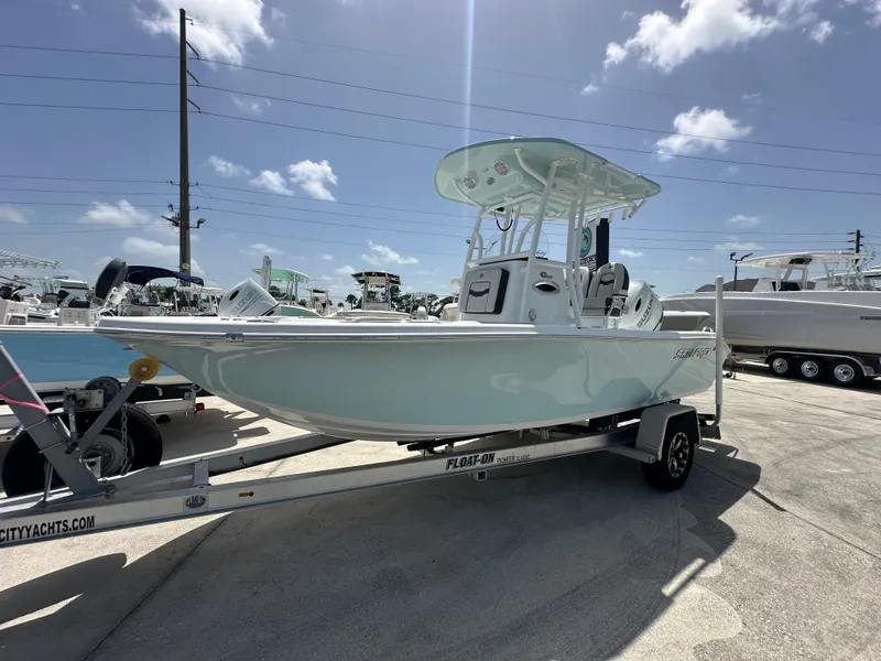 Slide: The Image of 2026 Sea Pro 202 Center Console boat on trailer under clear blue sky. - 2