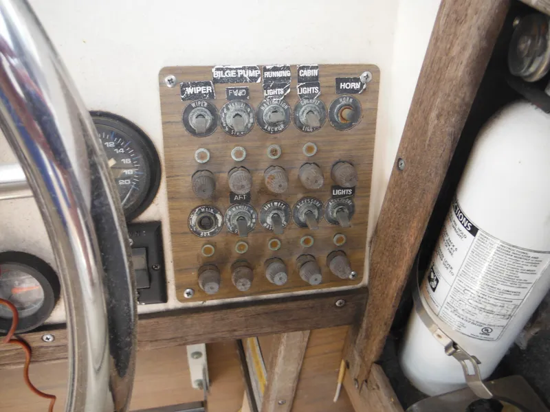 Slide: The Image of Control panel of a 1988 Grady-White Offshore 240 boat with switches and gauges. - 13