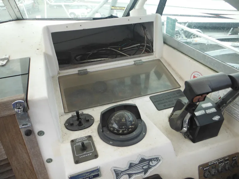 Slide: The Image of Control panel of a 1988 Grady-White Offshore 240 boat, featuring navigation instruments and throttle controls. - 14