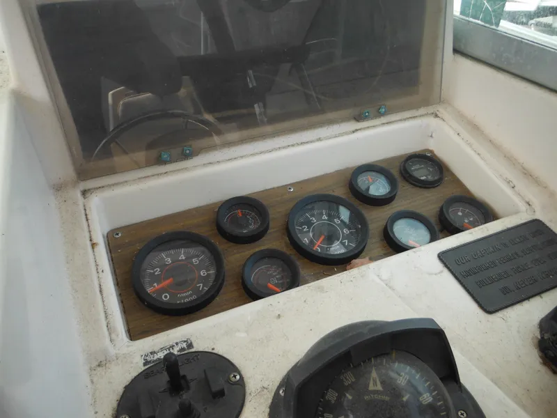 Slide: The Image of Dashboard of a 1988 Grady-White Offshore 240 boat with gauges and controls. - 15