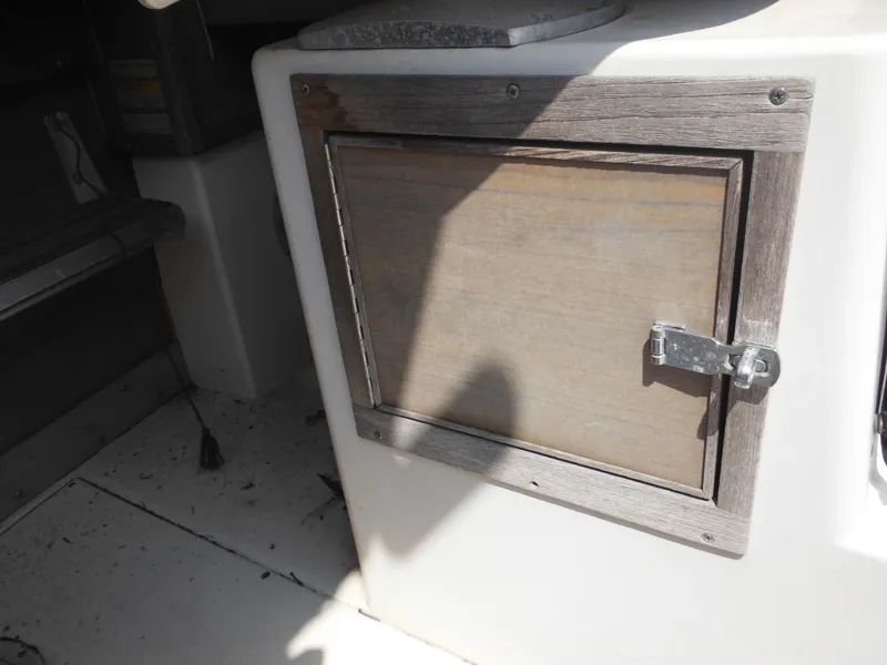 Slide: The Image of 1988 Grady-White Offshore 240 boat interior with wooden storage compartment. - 17