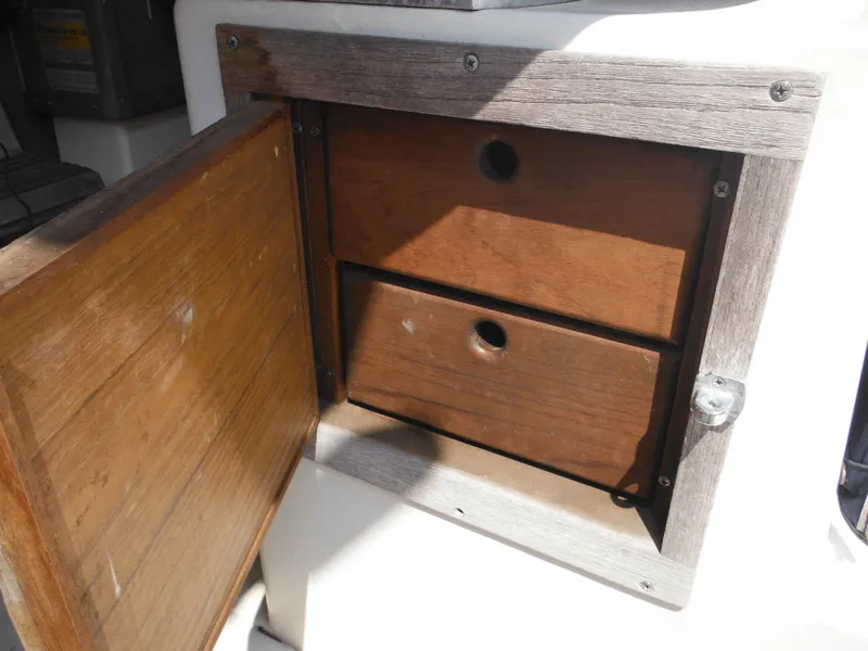 Slide: The Image of Open wooden storage compartment on 1988 Grady-White Offshore 240 boat. - 18