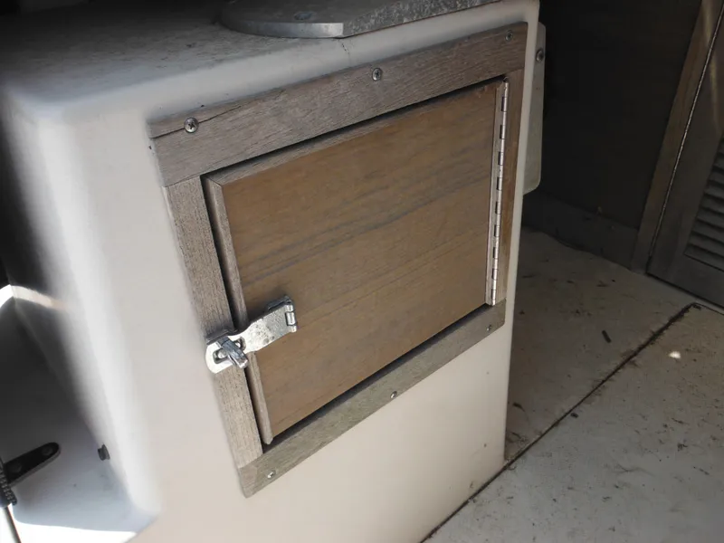 Slide: The Image of Wooden cabinet door on a 1988 Grady-White Offshore 240 boat interior. - 19
