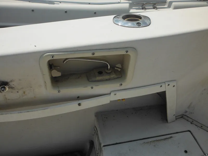 Slide: The Image of 1988 Grady-White Offshore 240 boat interior detail with rod holder and storage compartment. - 21
