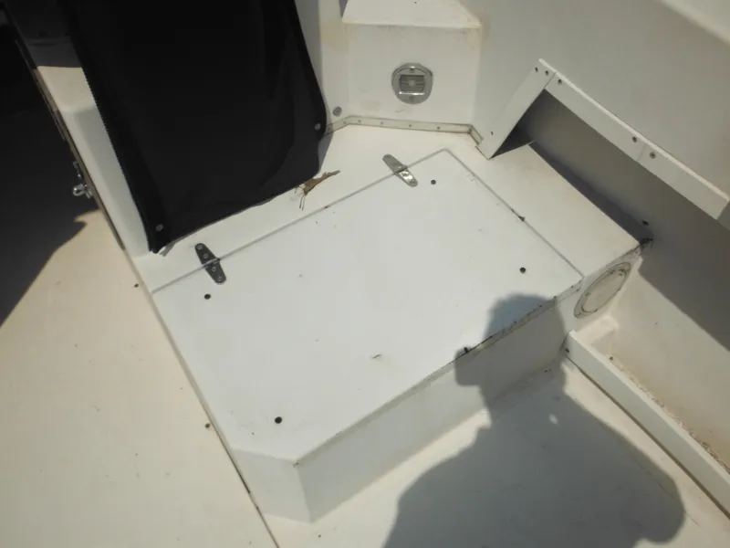 Slide: The Image of 1988 Grady-White Offshore 240 boat interior, featuring a white deck with storage compartment. - 24