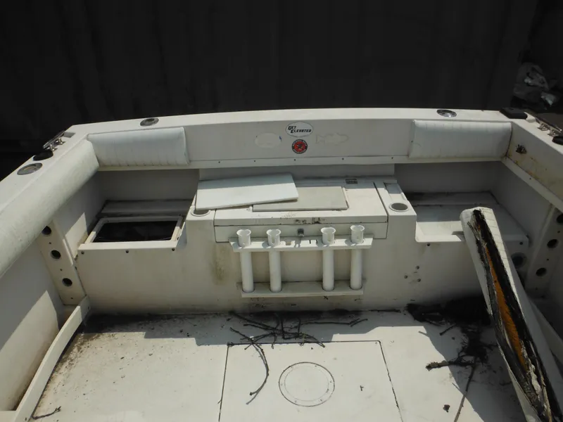 Slide: The Image of 1988 Grady-White Offshore 240 boat interior with rod holders and storage compartments. - 26